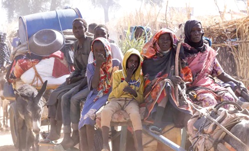 Displaced people riding an animal-drawn cart, following attacks by the rebel RSF on the Zamzam displacement camp, North Darfur, Sudan Displaced people riding an animal-drawn cart, following attacks by the rebel RSF on the Zamzam displacement camp, North Darfur, Sudan