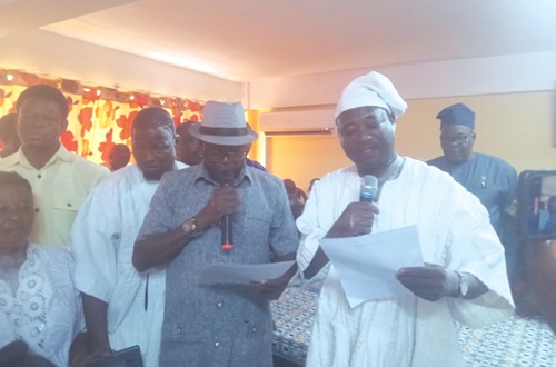 Donatus Akamugri Atanga (left), Upper East Regional Minister, swearing in Roland Atanga Ayoo (right), Bolgatanga MCE