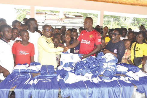 Edem Kofi Kpotosu (in spectacles), MP for Ho Central, presenting the items to Freeman Azumah, Ho Municipal Physical Education Coordinator, while some members of the contingent look on Edem Kofi Kpotosu (in spectacles), MP for Ho Central, presenting the items to Freeman Azumah, Ho Municipal Physical Education Coordinator, while some members of the contingent look on