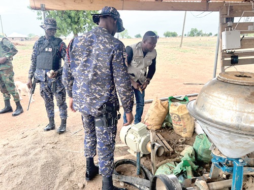 Members of the team inspecting some equipment at one of the sites of the illegal miners