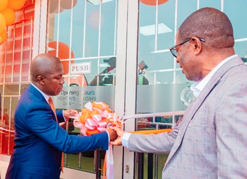 Kwesi Afreh Biney (left), Director-General of SSNIT, cutting the ribbon to inaugurate the Spintex Branch office. Assisting him is Peter Doe Ahadzi, former Accra North Area Manager