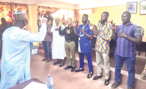 Alhaji Fuseini Zakaria (left), Upper East Regional Director of Agriculture, swearing in the leadership of GNAFF in the Upper East Region