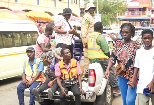  The task force moving along the Accra Regional Police Headquarters street in the bucket of the pickup truck 