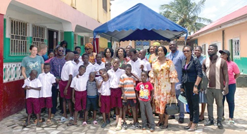 Members of the committee with some children and staff of the Save Them Young orphanage home after the event