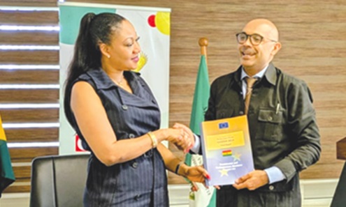 Irchad Ramiandrasoa Razaaly (right), EU Ambassador to Ghana, presenting a copy of the report to  Jean Mensa, chairperson of the Electoral Commission