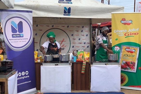 Sandra Ampofoa Ofosu (left) of Metro TV and Halliday Israel, Nigerian Chef showcasing their culinary skills The Mirror, Metro TV, Gino mark AU day with Jollof contest
