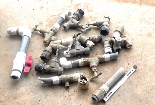 Some of the stolen stop corks and safety valves INSET: A water meter installed Some of the stolen stop corks and safety valves INSET: A water meter installed