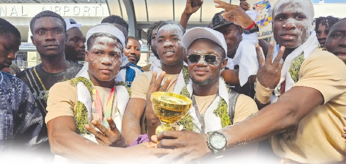 •The gold-winning Black Rockets team with their trophy upon arrival at the airport yesterday •The gold-winning Black Rockets team with their trophy upon arrival at the airport yesterday