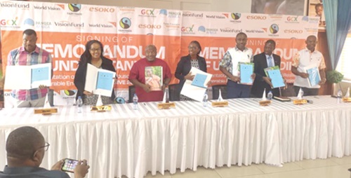 Partners in the deal displaying the  Memorandum of Understanding after it was signed 