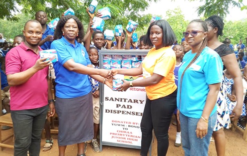 Mary Donkor (2nd from right), Financial Officer of YUWM, presenting a sanitary pad to Agnes Sarpong (2nd from left), a teacher at the Chiraa Presbyterian JHS Mary Donkor (2nd from right), Financial Officer of YUWM, presenting a sanitary pad to Agnes Sarpong (2nd from left), a teacher at the Chiraa Presbyterian JHS