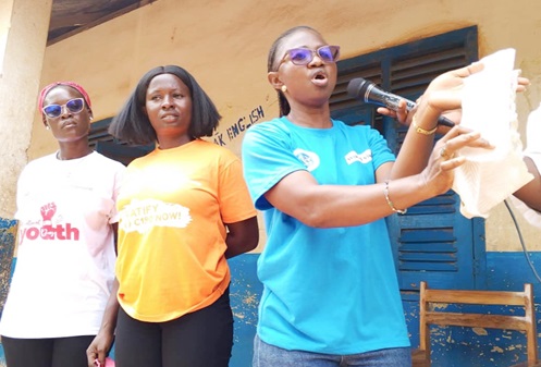 Constance Adogbama Ayambila (right), Gender Education Officer at the Sunyani West Municipal Education, demonstrating how to use sanitary pads