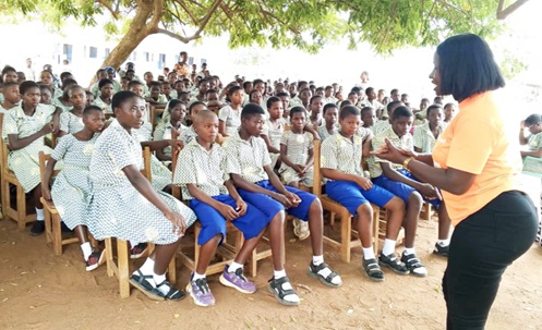Mary Donkor (right), Financial Officer of YUWM, speaking to the students of the Chiraa SDA School