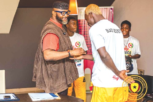 • Yaw Ampofo Ankrah (left), NSA boss, exchanging pleasantries with one of the Black Rockets boxers while others look on • Yaw Ampofo Ankrah (left), NSA boss, exchanging pleasantries with one of the Black Rockets boxers while others look on