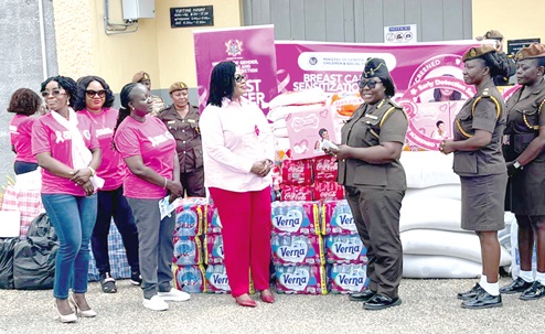 Dr Agnes Naa Momo Lartey (middle), Minister for Gender, Children and Social Protection, interacting  with Victoria Adzowoda (right), Deputy Director of Prisons,­ at the launch.