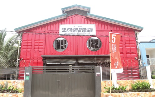 Isaac Tetteh (right), Head of Welding, Design and Technical Institute, conducting Constance Swaniker (2nd from right), founder, Design and Technical Institute, and other dignitaries round the newly commissioned centre. INSET: The front view of the newly commissioned DTI Training and Testing Centre. Picture: ERNEST KODZI 