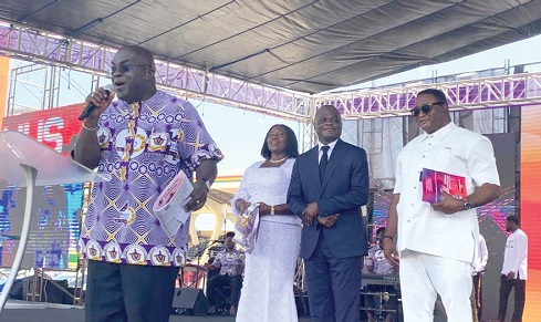 Julius Debrah, Chief of Staff, addressing the congregation as Elvis Afriyie Ankrah (right), the Presidential Envoy in charge of Interfaith and Ecumenical Bodies, and Ahmed Ibrahim (middle), the Minister of Local Government, Chieftaincy and Religious Affairs, and his deputy, Rita Naa Odoley Sowah (left), offer their support