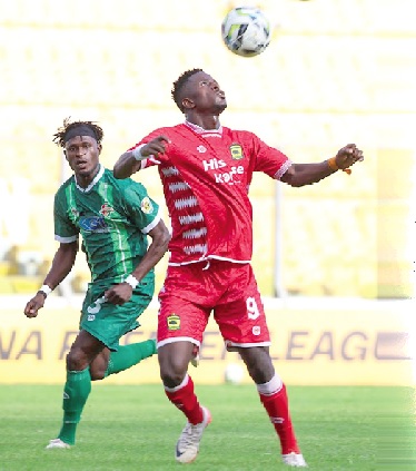Kotoko’s Morifing Donzo heads the ball away from his Karela United marker during the game yesterday