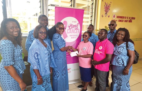 Sister Gifty Maloe Nartey (3 from left), presenting the cash to Augusta Gening (3 from right), the Nurse in Charge of the Surgical Oncology Unit of KBTH
