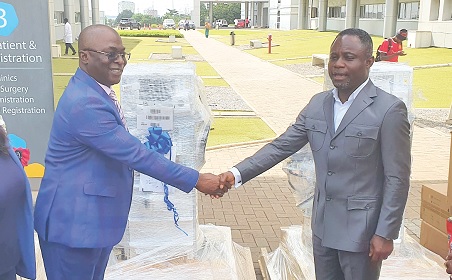 Kwabena Mintah Akandoh (right),  Minister of Health, in a handshake with Dr Abdul -Samed Tanko, CEO, UGMC, after the  presentation. Picture: ERNEST KODZI