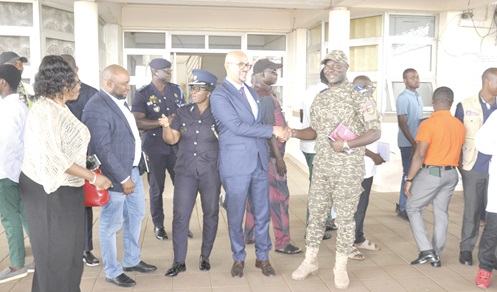 Members of the visiting delegation interacting with customs and immigration  personnel at the Akanu Joint Border Post