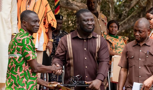 Dr Frank Amoakohene (2nd from right), the Ashanti Regional Minister, presenting one of the laptops to Collins Owusu, the headmaster of the school, during the event 