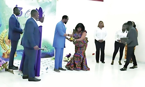 Apostle Florence Tigah (arrowed), CEO of Vita Legacy,  presenting an award to Dr Bishop Samuel Ben Owusu, AU Envoy for Agenda 2063 and UN Ambassador, whiles other members look on
