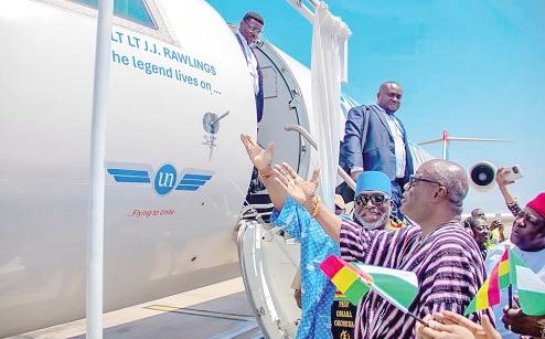 Fritz Baffour (right), a former Member of Parliament for Ablekuma South, assisted by Prof. Obiora Okonkwo (left), the Founder of United Nigeria Airlines, and other dignitaries to unveil the name of late Jerry John Rawlings designed on the aircraft