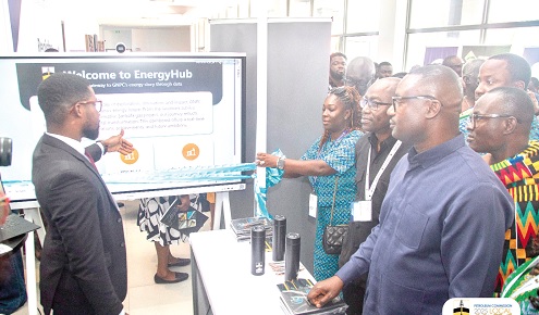 An official of the GNPC explaining a point to John Abdulai Jinapor (right), Minister for Energy and Green Transition, and Kwame Ntow Amoah (2nd from right), acting CEO, GNPC, at the exhibition booth