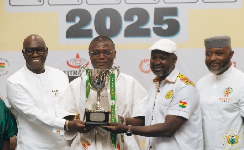 Mr Kofi Adams, Sports Minister and other dignitaries displaying the trophy at stake