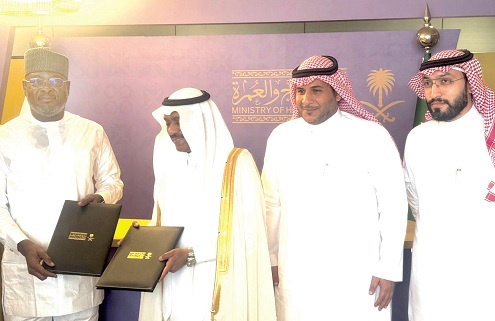 Alhaji Abdul-Rauf Tanko Ibrahim (left), Chairman, Pilgrims Affairs Office of Ghana, and Tawfiq Al-Rabiah, Minister of Hajj and Umrah, Saudi Arabia, displaying the signed documents
