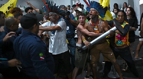 Chaos at COP30 as indigenous protesters force their way into climate summit and clash with security guards