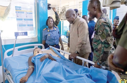 President John Dramani Mahama (2nd from right) commiserating with one of the victims during his visit to the hospital 