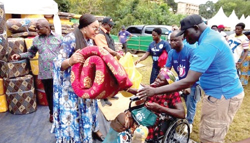 Irene Naa Torshie Addo-Lartey, Executive Director of Reneaddo Foundation, with the support of members of the CEM, presenting some relief items to some persons with disability