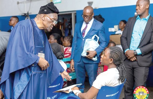 Alban Sumana Kingsford Bagbin (left), Speaker of Parliament, in a chat with one  of the victims at the 37 Military Hospital 