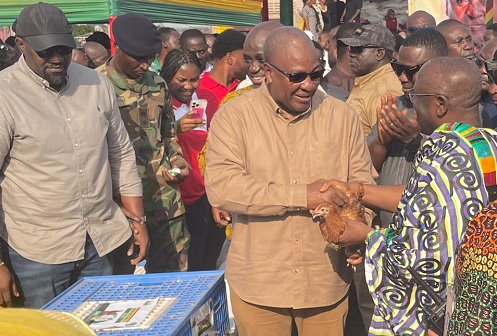 President John Dramani Mahama handing over a fowl to Akyamfour Asafo Boakye Agyemang(in Kente), the Asafohene, to officially launch the &quot;Nkoko Nketenkete&quot; initiative in Kumasi. Looking on is John Dumelo(left) , Deputy Minister of Food and Agriculture. Picture: EMMANUEL BAAH