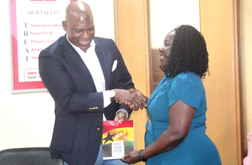 Ato Afful (left), MD, GCGL, presenting the Ghana Year Book to Dr Enyonam Kpekpena, Executive Director, GhIE.  Picture: ESTHER ADJORKOR ADJEI 