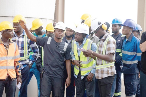 An official of Karpower (arrowed) explaining a point to the students during the tour of the Powership