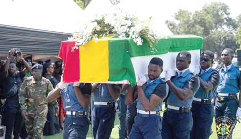 The remains of Cecilia Johnson being carried by pallbearers after the burial service
