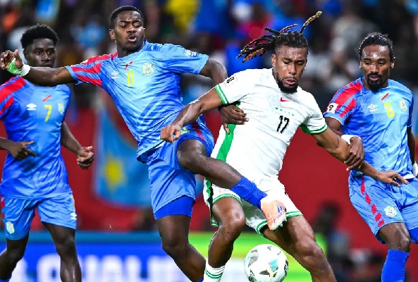 Nigeria’s Alex Iwobi battles for the ball with his DR Congo opponents during the game