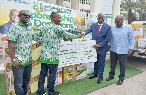 George Selassie Ocloo (2nd from left), Technical Manager of Rainbow AgroSciences Ltd, presenting the agrochemical inputs and dummy cheque for GH¢30,000 to Eric Opoku (2nd from right), Minister of Food and Agriculture, while Harrison Ahorgba (left), Head of Sales and Marketing of the company, looks on