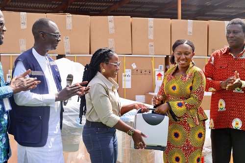 Abena Amedormey (2nd from left), Country Representative of CRS, presenting the items to Evenlyn Amoako (2nd from right), an official of the Ministry of Health. Looking on is Dr Chrysantus Kubio (right), Northern Regional Director of Health Services, and an official of CRS