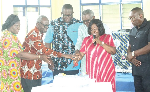 Harriet Lomotey (2nd from right), Director of Education of La Nkwantanang Madina;  Charles Aheto-Tsegah (3rd from right), former Director-General, GES;  Angel Cabonu (3rd from left), President of NAGRAT, being assisted by Samuel Ofori-Adjei (2nd  from left), Chairman of the association of retired heads, to cut the induction cake.  Picture: ESTHER ADJORKOR ADJEI­