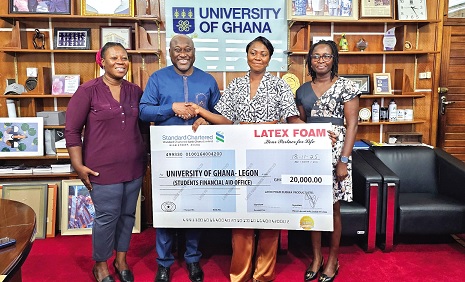 Gifty E. Appiah (2nd from right), PRO, Latex Foam, presenting a dummy cheque to Prof. Gordon Awandare, Pro-Vice Chancellor, Academic and Students Affairs, University of Ghana. With them is Selina Saaka (left), Head of Students Aid Financial Office