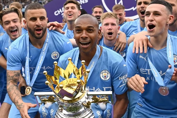 Fernandinho (with trophy) celebrates winning the 2021/22 Premier League, his fifth league title