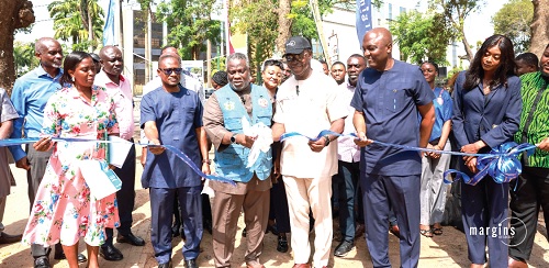 Alfred Allotey-Gaisie (3rd from left), MCE of KoKMA, and Kwesi Baiden Jnr (3rd from right), CEO of Margins, cutting the tape for the project to start