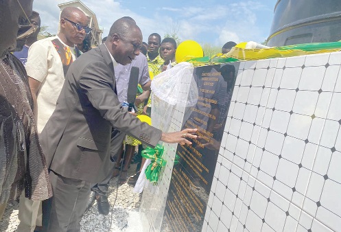 Isaac Kwame Boateng, the Oda Methodist Diocesan Bishop, blessing the borehole during its inauguration