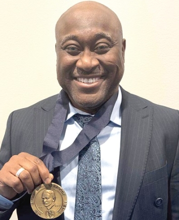 Professor Gordon Awandare displaying the international medal he received