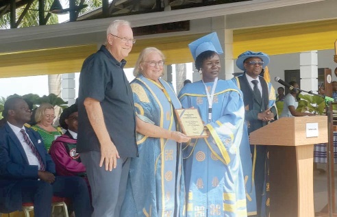 A graduating student receiving her award from Dr Lynette Gay, one of the founders               