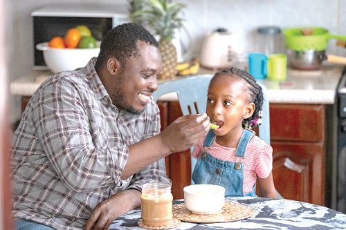 A father feeding his child