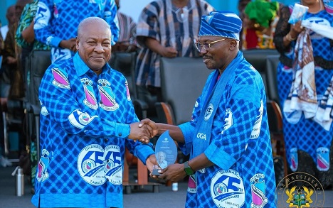 President Mahama receiving a gift from Douglas Yakubu, Headmaster of GHANASCO